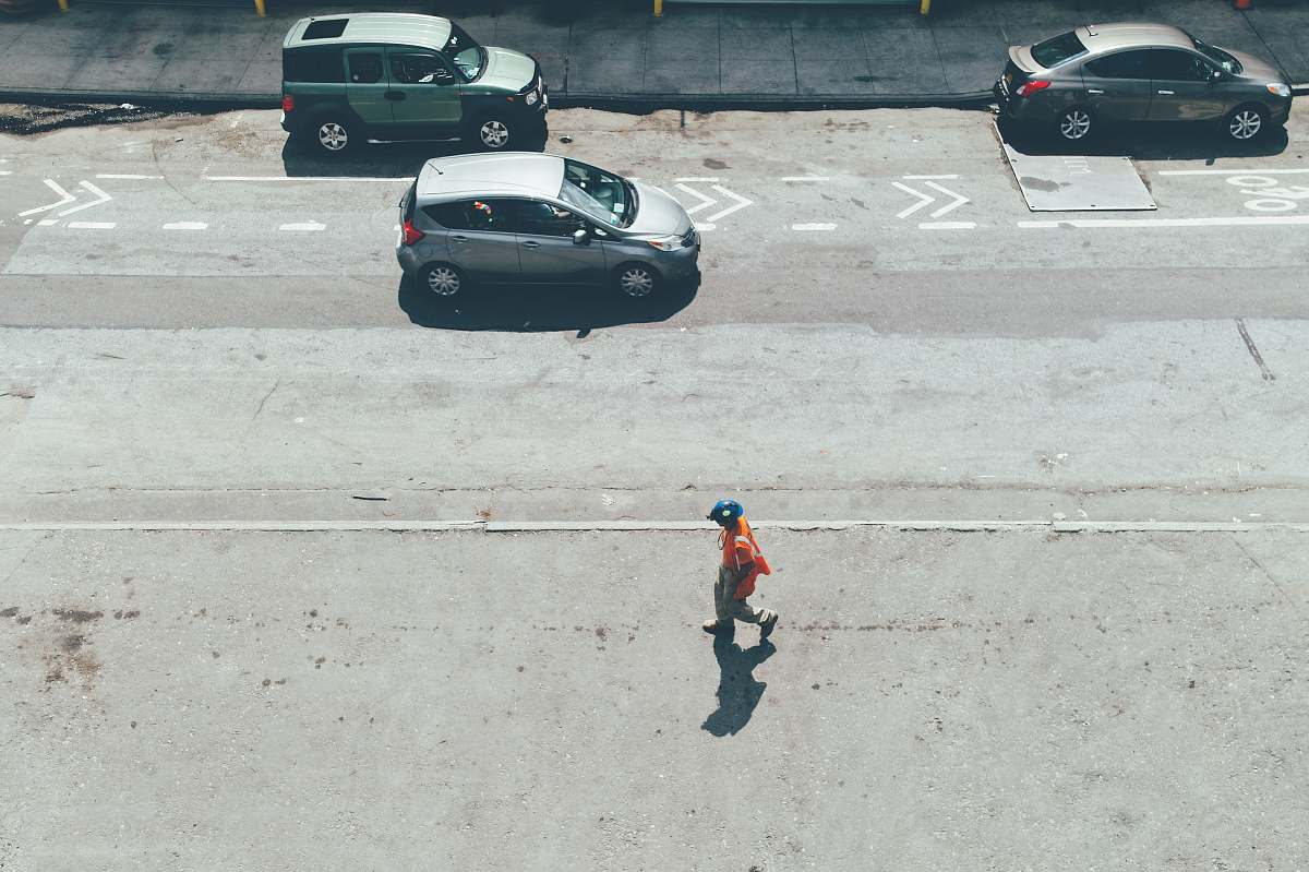 united states person walking on road near vehicles at daytime new york
